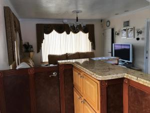 a living room with a kitchen with a counter top at Red Carpet Inn Daytona Beach in Daytona Beach