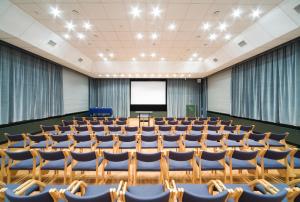 an empty lecture hall with chairs and a podium at Hotel IOR in Poznań
