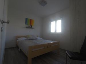 a small bedroom with a bed and a window at Apartment Lola in Srima