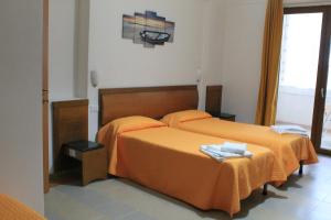 Ένα ή περισσότερα κρεβάτια σε δωμάτιο στο B&B Palazzo Manfredi Vieste vista mare con Parcheggio