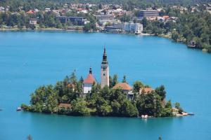 an island with a church in the middle of a lake at Bled4U Apartment in Bled +17 photos
