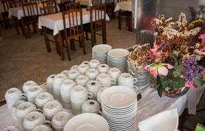 a table with white plates and vases on it at Mobile homes Bonaca in Srima +51 photos