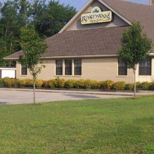 a building with a sign on the side of it at Riverwood Inn in Glenwood