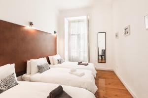 Ein Bett oder Betten in einem Zimmer der Unterkunft LV Premier Apartments Baixa- CR