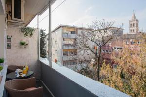 a balcony with a table and a view of a city at Royal View Apartment in Zadar