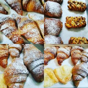 a bunch of different types of pastries on a table at Piccolo Hotel in Rosignano Solvay