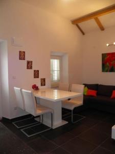 - un salon avec une table, des chaises et un canapé dans l'établissement Romantic apartment, à Koločep