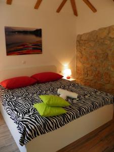 a bedroom with a zebra print bed with a lamp at Romantic apartment in Koločep