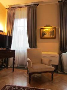 a living room with a chair and a window at L'Approdo di Sant'Agostino in Como