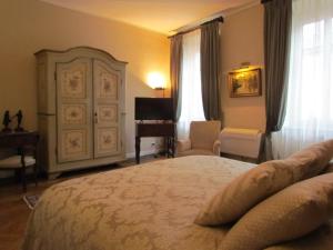 a bedroom with a large bed and a piano at L'Approdo di Sant'Agostino in Como