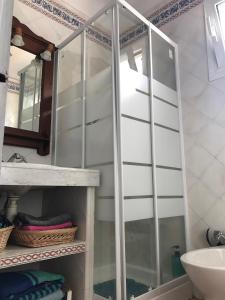a glass shower in a bathroom with a sink at Apartamento Rural situado en tercera planta sin ascensor in Navás