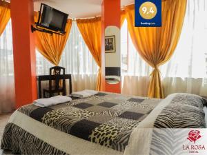a bedroom with a bed with orange walls and curtains at Hostal La Rosa Otavalo in Otavalo