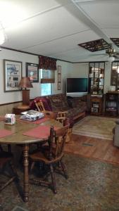 a living room with a table and a couch at Wolf Creek Farm B&B and Motorcycle Manor at Wolf Creek Farm, LLC in Ararat