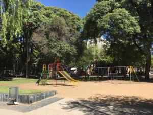 a playground in a park with a slide at Apartamento Gutierrez in Mendoza