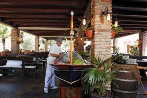 a chef preparing food on a buffet in a restaurant at Apartment Doris in Šibenik