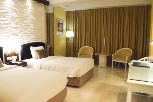 Krevet ili kreveti u jedinici u okviru objekta Hotel New Saphir Yogyakarta