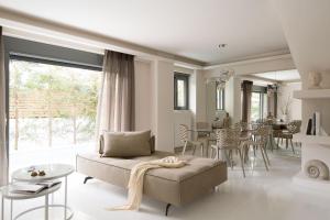 a living room with a couch and a table at Elaia Luxury Condo Glyfada in Athens