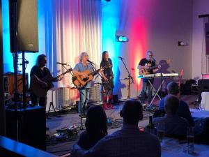 a group of people playing music on a stage at Hotel Svornost in Prague