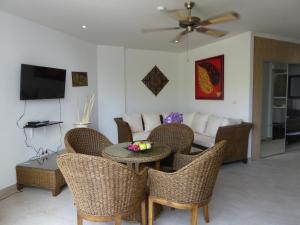 The Orchid Beach Resort @ VIP Chain Resort في بان فيه: غرفة معيشة مع طاولة وكراسي وأريكة