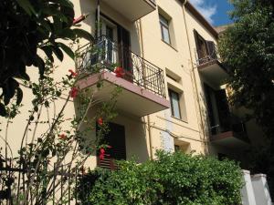un edificio con 2 balcones y flores. en Il Giardinetto, en Alghero