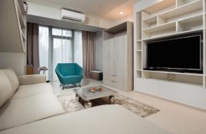 
a living room filled with furniture and a tv at Boban Luxury Suites in Split
