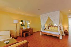 a bedroom with a bed with a canopy at Dreamland Maldives Resort in Baa Atoll