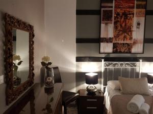 a bedroom with a bed and a mirror and a desk at 3Jolie in Verona
