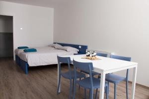 a bedroom with a bed and a table and chairs at Ingrappa Sporthouse in Borso del Grappa