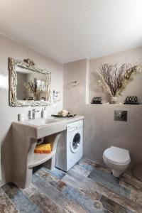 a bathroom with a sink and a washing machine at Relax Studios in Naxos Chora