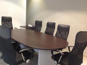 a conference room with a wooden table and black chairs at Hotel Punta Azul in Veracruz