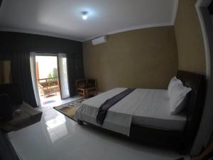 a bedroom with a large bed in a room at Khoo Villa in Senggigi 