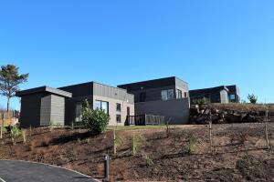 a house on top of a hill with a yard at Dalriada Lodges Carlin in Stonehaven