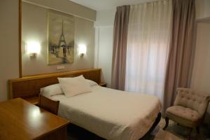 Postel nebo postele na pokoji v ubytování Hotel Escudero