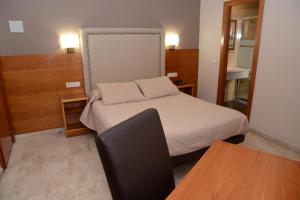 Postel nebo postele na pokoji v ubytování Hotel Escudero