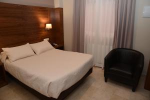 Postel nebo postele na pokoji v ubytování Hotel Escudero