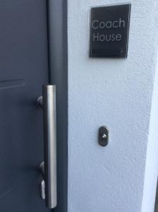 a door with a sign that reads coach house at Coachhouse in St Ives