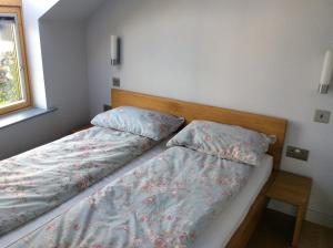 a bedroom with two twin beds and a window at Coachhouse in St Ives