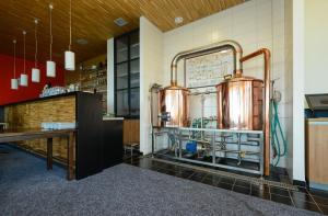 a kitchen with two large copper pots on the wall at Penzion Andula Friesovy boudy in Strážné