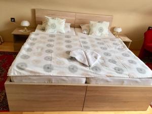 A bed or beds in a room at Németh Vendégház