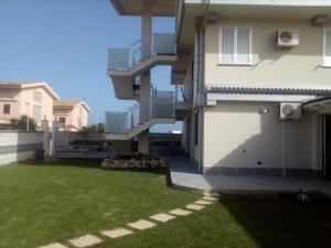 a view of a house with a yard at Rooms STELLA POLARE in Portopalo +14 photos