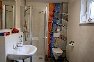 a bathroom with a sink and a shower at Ferienwohnung Westend in Kappel-Grafenhausen +21 photos