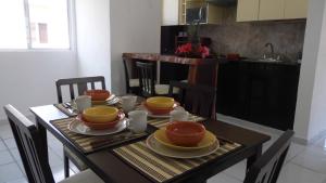 a dining room table with plates of food on it at Relaxing Puertomorelos in Puerto Morelos
