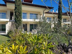 an apartment building with plants in front of it at Luxury Apartments Beauty Gardens in Sirmione