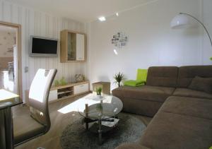 a living room with a couch and a table at Ferienwohnung Traumblick in Bad Sachsa