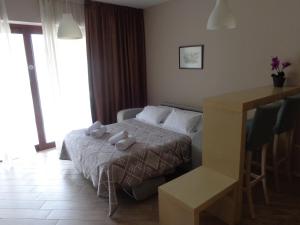 a bedroom with a bed with two stuffed animals on it at Apartments Bella di Mare in Kotor