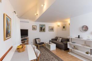 a living room with a couch and a table at Apartment Tomic in Dubrovnik