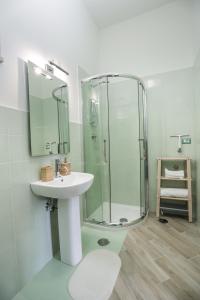 a bathroom with a sink and a glass shower at Le Fontanelle B&B in Sarno