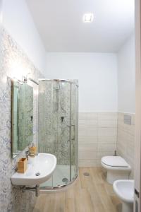 a bathroom with a shower and a sink and a toilet at Le Fontanelle B&B in Sarno