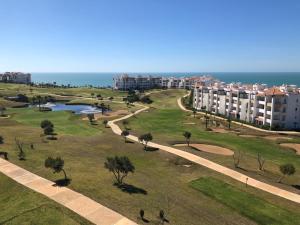 a view of a park with buildings and a lake at Marina Golf Appart Chez Hicham in Asilah