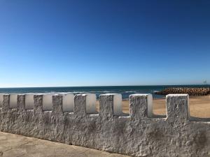 a retaining wall at the beach at Marina Golf Appart Chez Hicham in Asilah